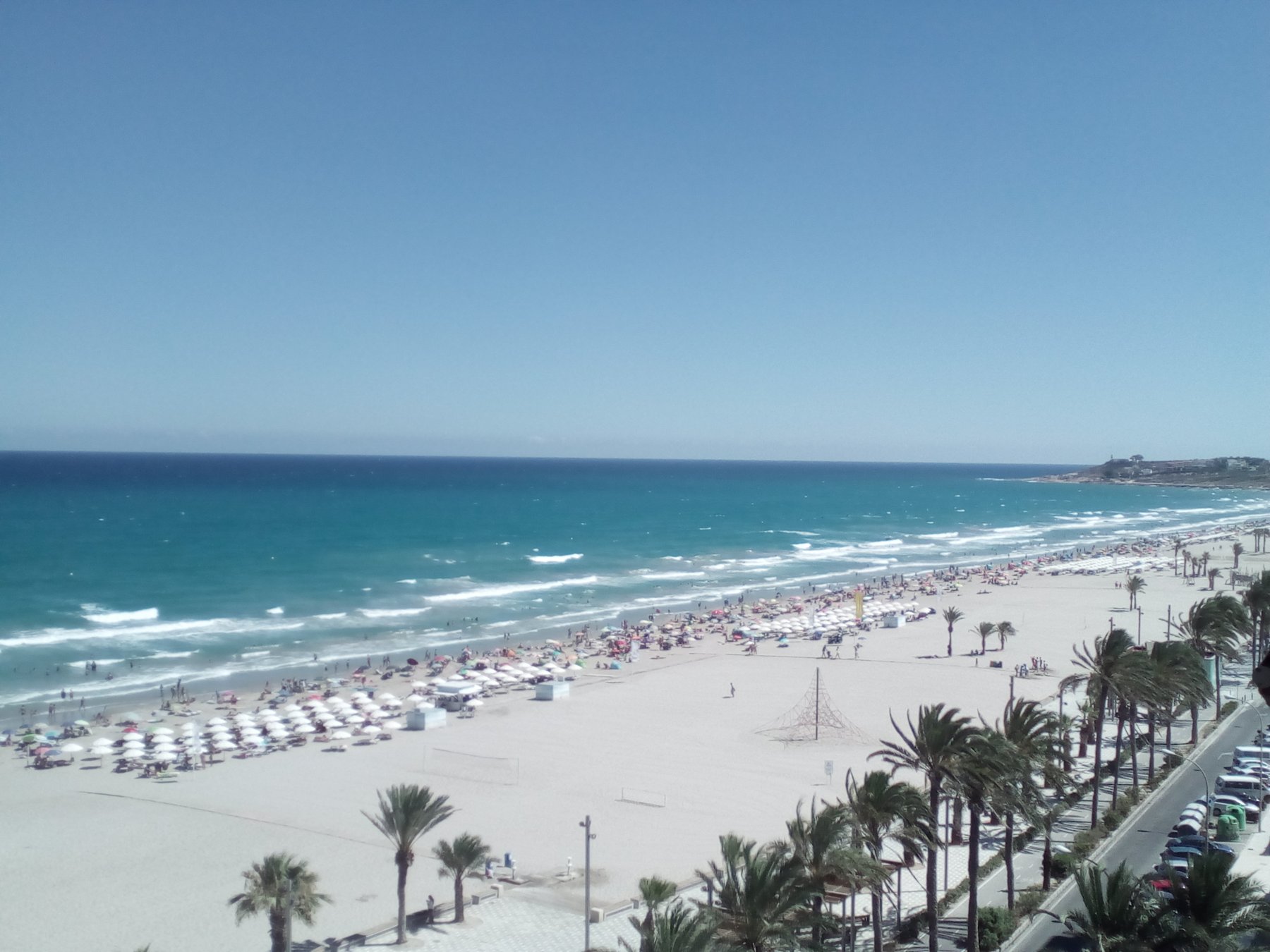 The wide sandy shoreline of Playa de San Juan in Alicante on a clear day